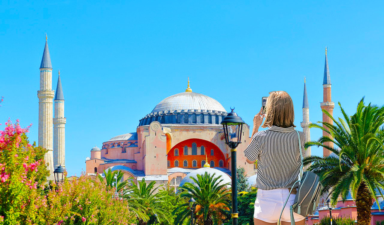 Tourist photographing the exterior of Hagia Sophia in Istanbul