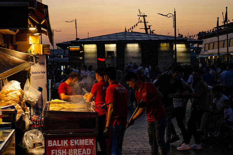 Fresh fish being grilled for making balik ekmek sandwiches