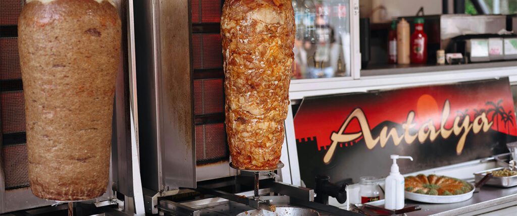 Rotating doner kebab roasting in a street food shop in Istanbul