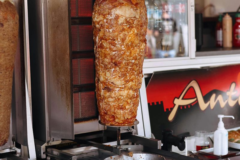 Rotating doner kebab roasting in a street food shop in Istanbul