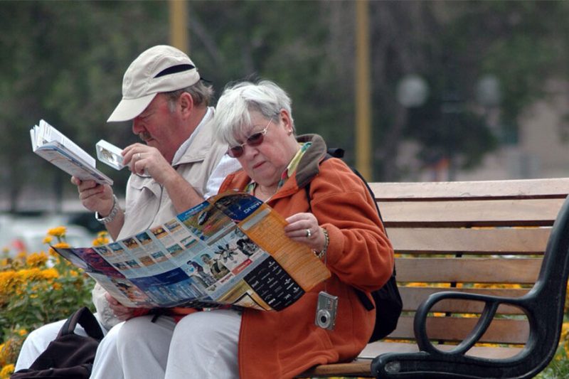 Two tourists studying a map with a local guide in Istanbul
