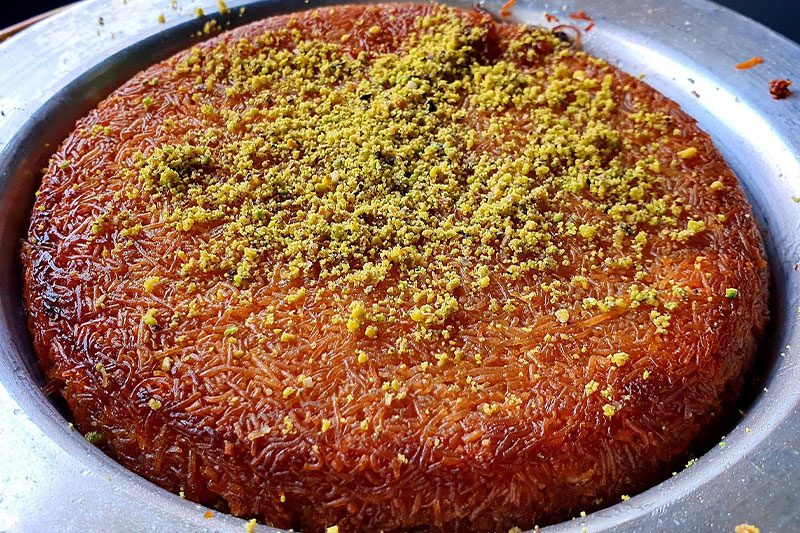 Turkish künefe dessert with melted cheese and crispy shredded pastry